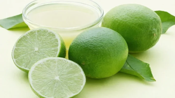 Vaso de agua tibia con rodaja de limón fresco y fondo natural, listo para tomar en ayunas